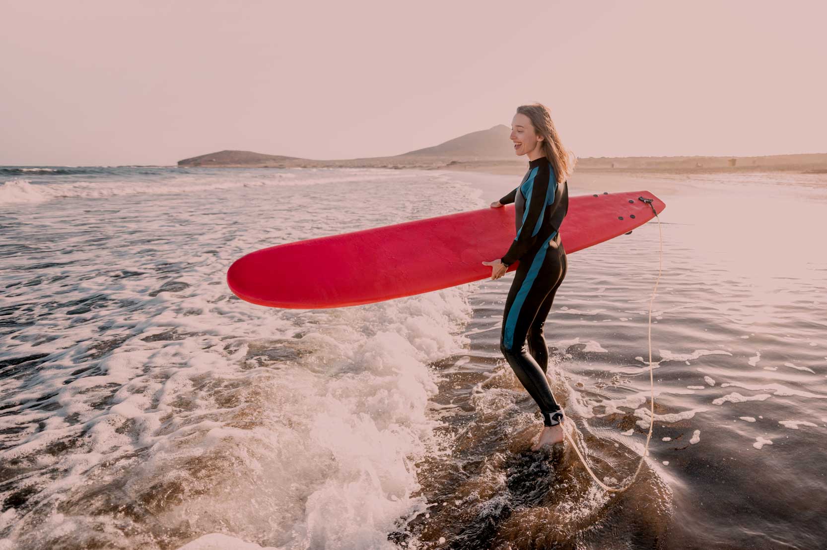 Surfer standing in the ocean