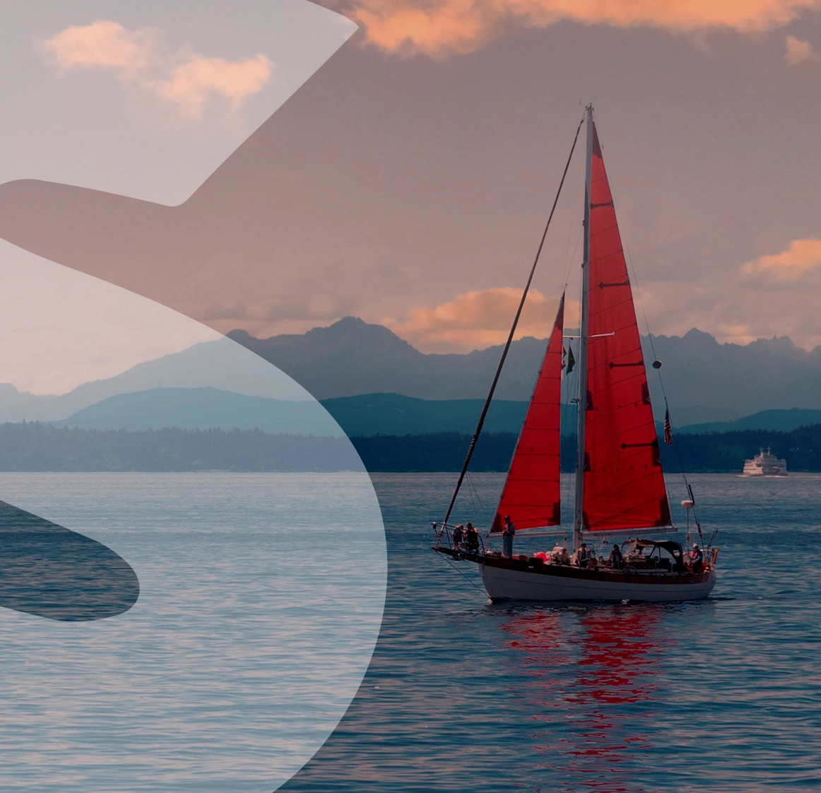 red boat sailing across the ocean